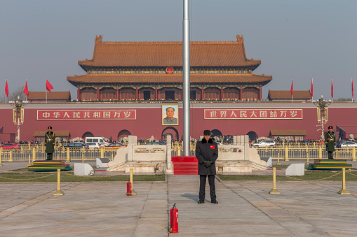 Beijing, China - December 5, 2015: Tianamen Square is a famous tourist attraction in Beijing, China. A few Chinese army guard standing in the front of the Tiananmen Square,which is the south entrance of the Forbidden City.
