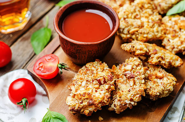 istock almond crusted chicken tenders with tomato sauce 505899014
