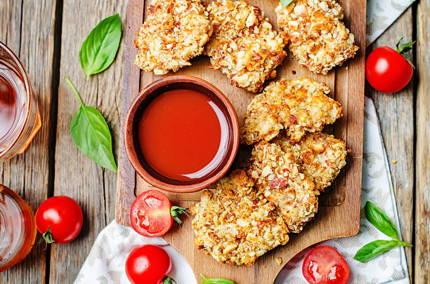 istock almond crusted chicken tenders with tomato sauce 505899376