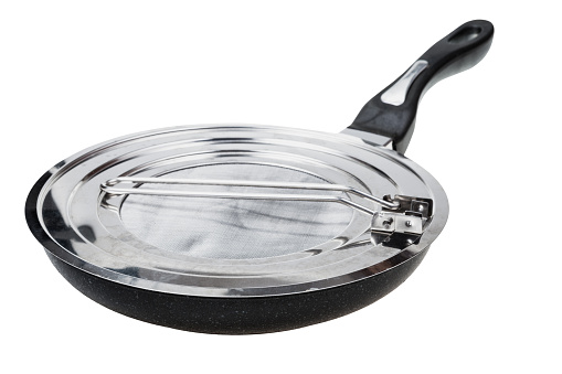 steel frying pan closed by splatter screen isolated on white background