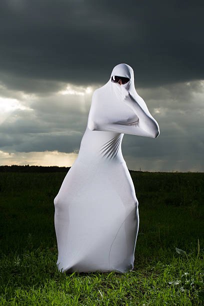 istock Shapeless white ghost against the background of gray sky 505912857