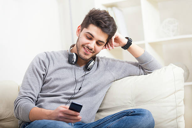 istock Beautiful young man looking at his smart phone 505913106
