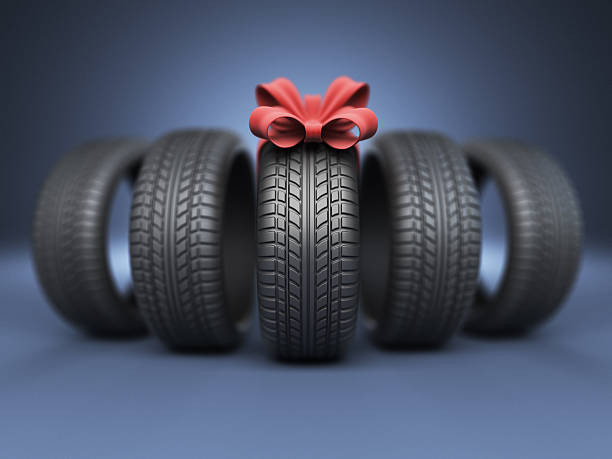 Tyre with a red ribbon. Gift 3D stock photo