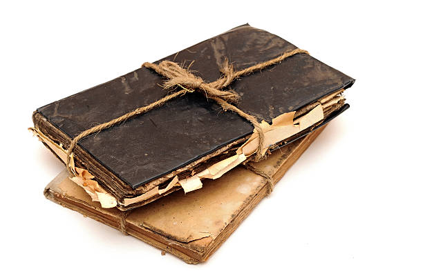 istock Stack of old books tied with rope isolated on white 505913965