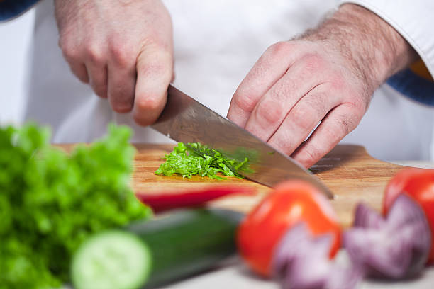 istock Chef cutting a green lettuce his kitchen 505914788