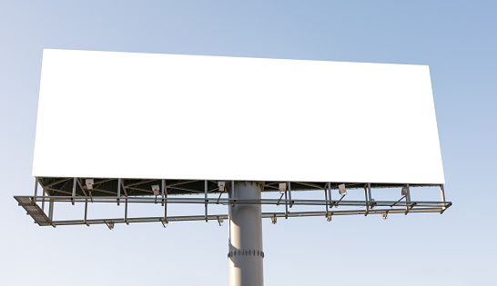 Blank billboard over blue sky background.