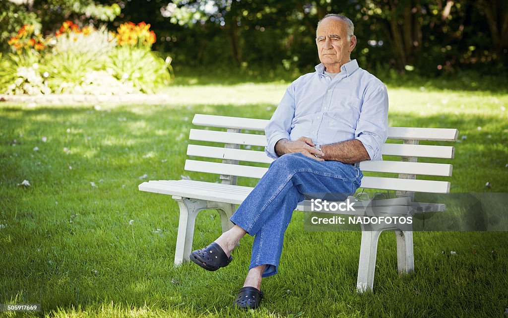 Senior Man Alone At The Park Day Dreaming Stock Photo