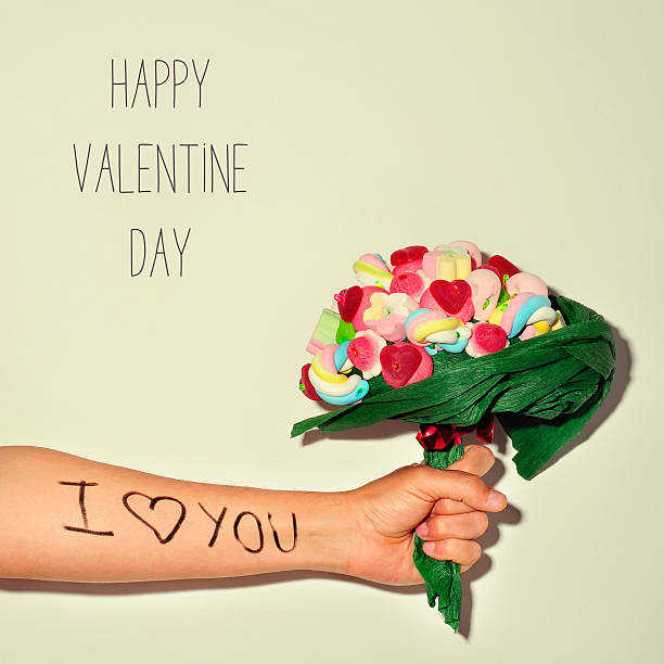 istock man offering a candy bouquet and text happy valentines day 505918112