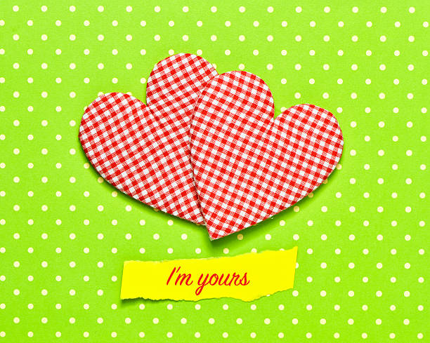 two red and white checkered hearts and the text I am yours on a colorful green dot-patterned background