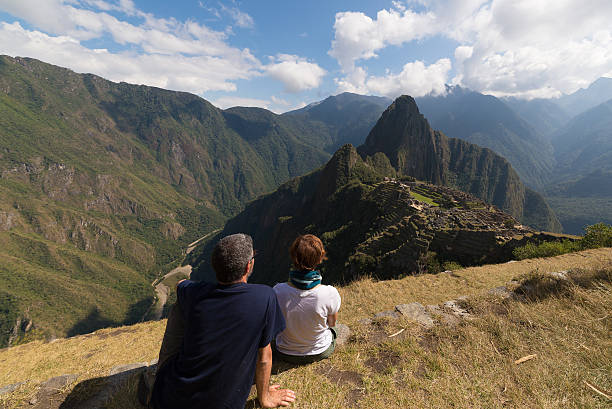 istock Couple looking at Machu Picchu, Peru, from above 505919584