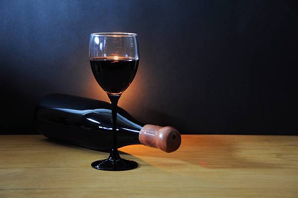 istock Wine glass and old bottle on a wooden table 505920100