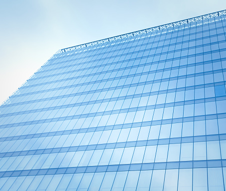 reflecting sky in glass of office building ; abstract background