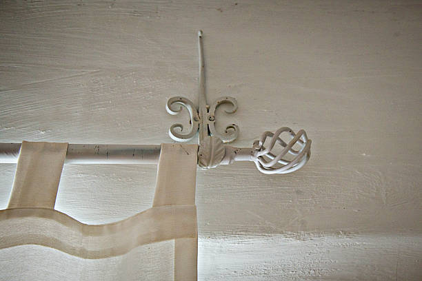 istock Wrought Iron Curtain Rod on White Adobe, Full frame 505921184