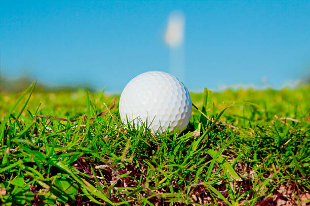 istock golfball on edge of  bunker with green infront 505921876