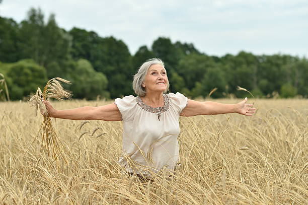 istock senior woman in summer field 505923180