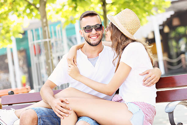 istock Happy couple kissing on a bench 505924192