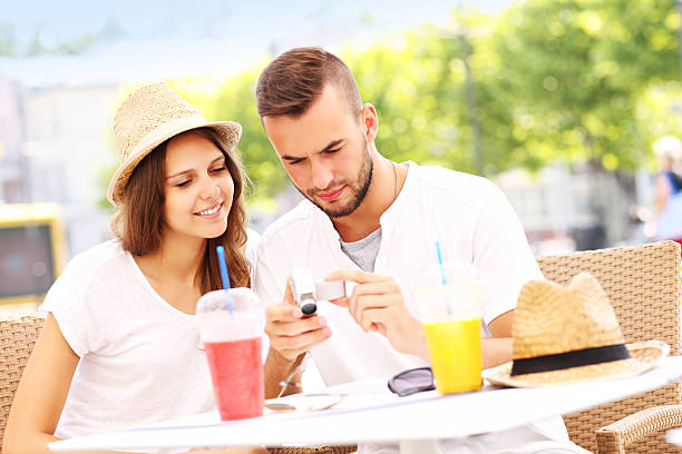 istock Tourists checking pictures in a cafe 505924300