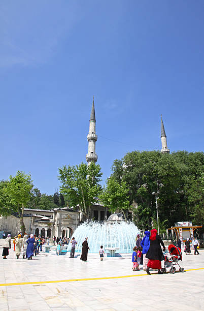 Istanbul, Turkey - May 8, 2012: People walking near The Eyup Sultan Mosque in Eyup district of Istanbul. Built in 1458, it was first mosque constructed by the Ottoman Turks in the city