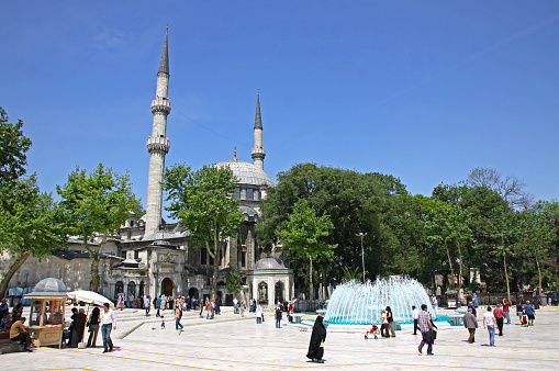 Istanbul, Turkey - May 8, 2012: People walking near The Eyup Sultan Mosque in Eyup district of Istanbul. Built in 1458, it was first mosque constructed by the Ottoman Turks in the city