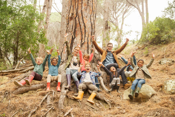 Students and teachers cheering in forest  field trip stock pictures, royalty-free photos & images