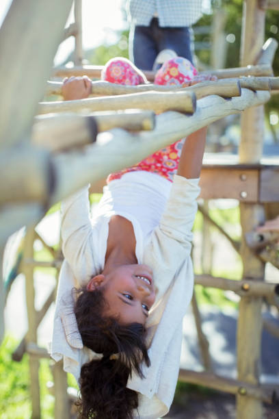 istock Girl climbing on monkey bars on playground 505935797