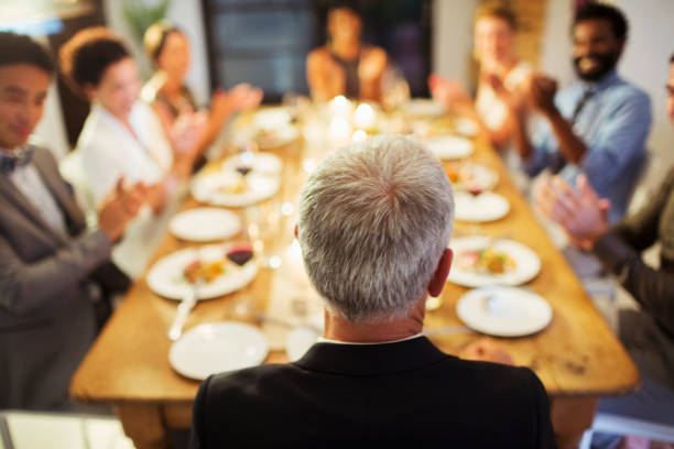 istock Friends applauding at dinner party 505935815