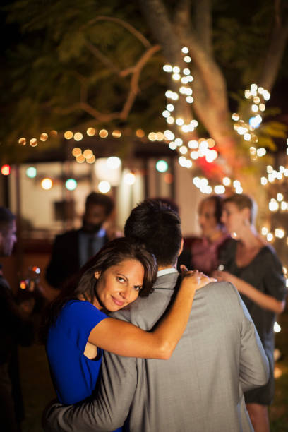 istock Couple hugging at party 505935917