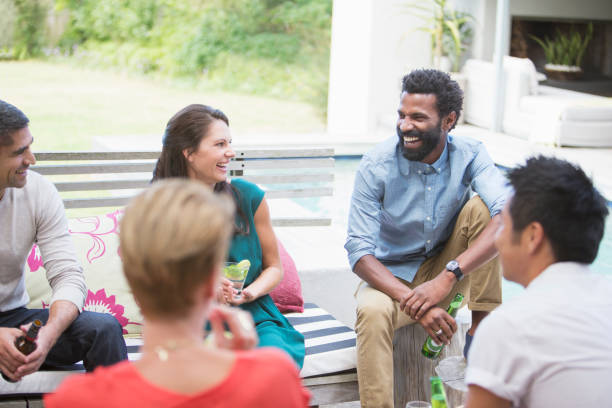 istock Friends laughing at party 505935997