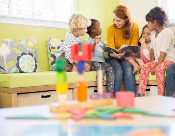 Teacher and students reading in classroom  preschool building stock pictures, royalty-free photos & images