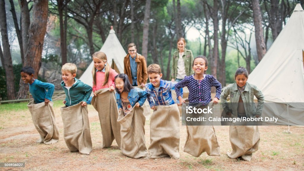 Children having sack race at campsite  Summer Camp Stock Photo
