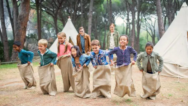 Photo of Children having sack race at campsite