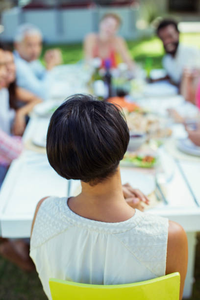 istock Woman sitting at table outdoors 505936313