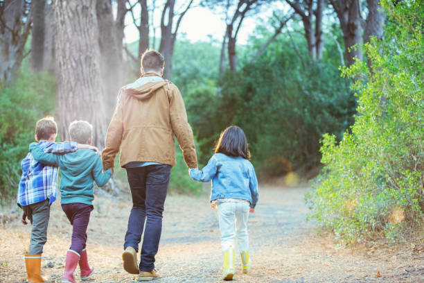 istock Students and teacher walking in forest 505936335