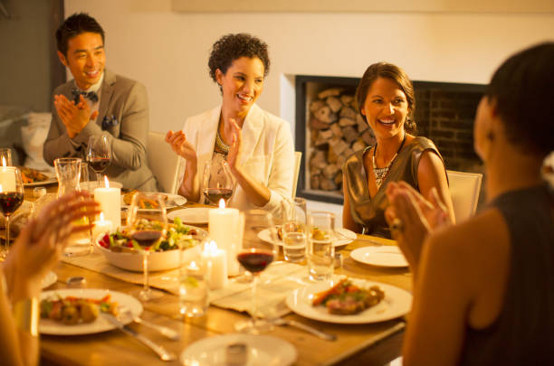 istock Friends applauding at dinner party 505936365