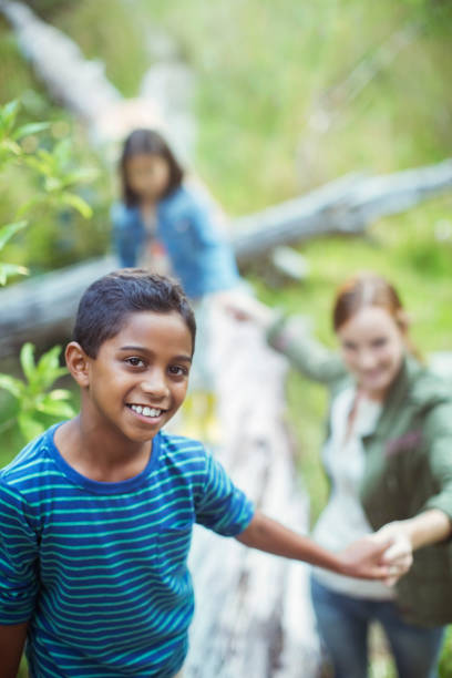 istock Students and teacher walking in forest 505936397