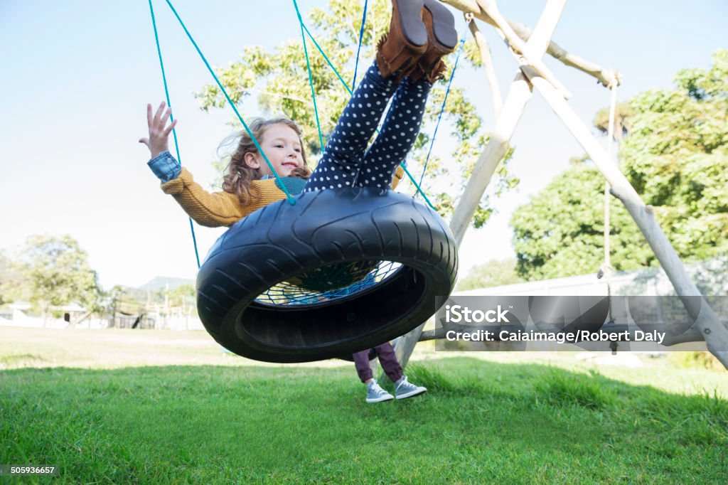 Children playing on tire swings  4-5 Years Stock Photo