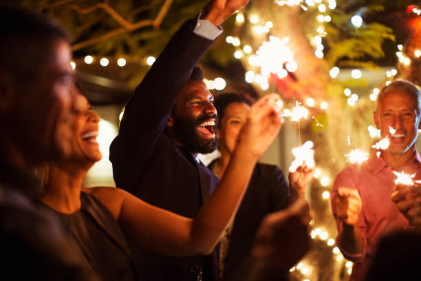 istock Friends playing with sparklers at party 505936675