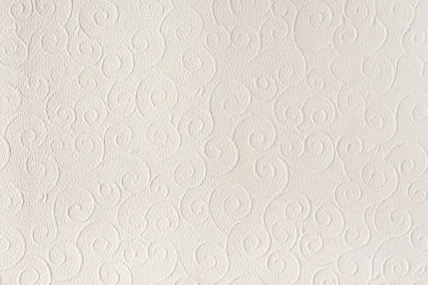 Old white, beige paper sheet texture background. Shells, waves, circles, shapes embossed pattern. Strong light, shadows.