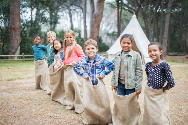 Children smiling at start of sack race  travel9 stock pictures, royalty-free photos & images