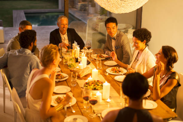 istock Friends eating together at dinner party 505936705