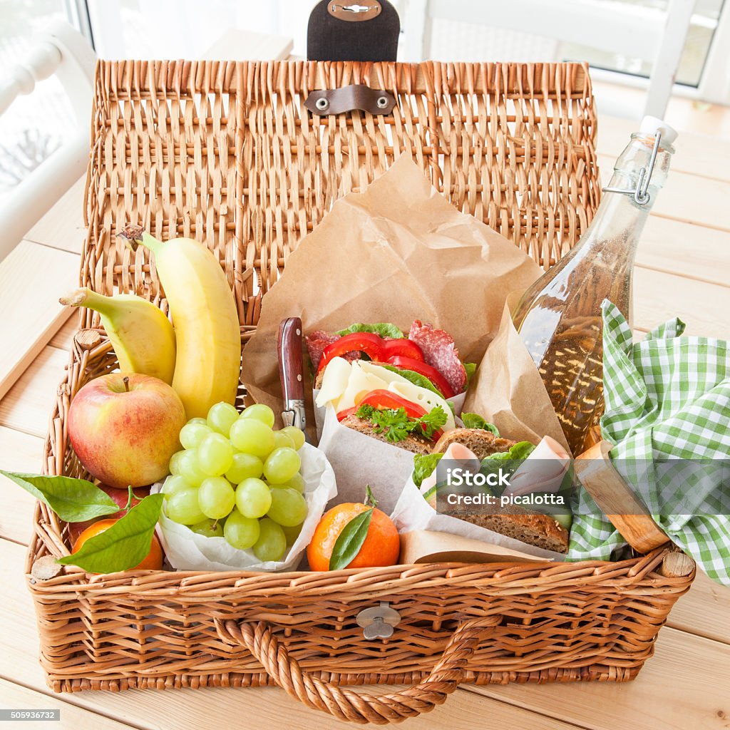 Filled picnic basket Filled picnic basket with sandwiches and fresh fruits Picnic Basket Stock Photo