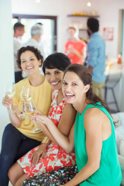 istock Women smiling together at party 505936807