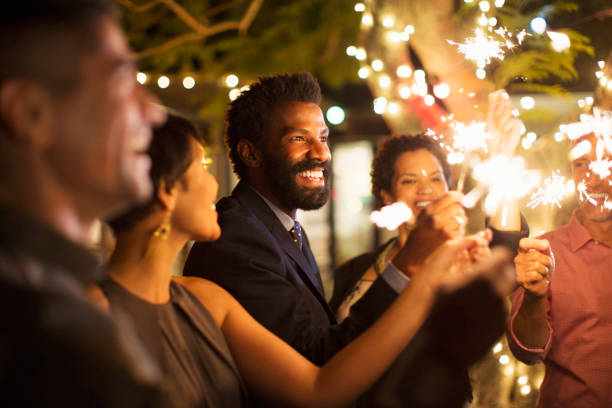 istock Friends playing with sparklers at party 505936827