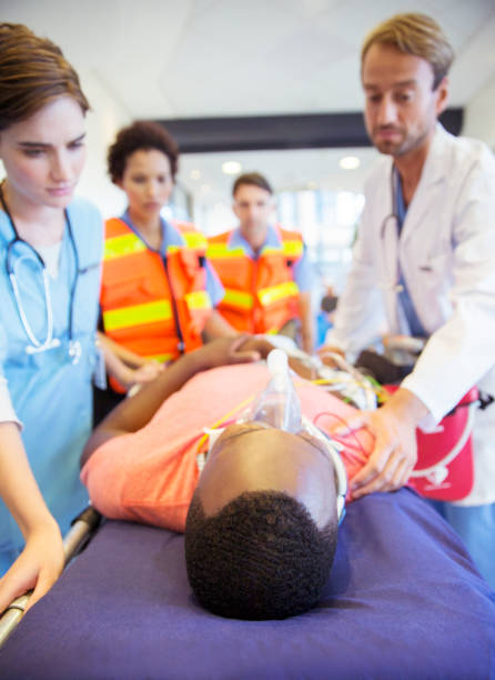 istock Doctors and nurses wheeling patient down hospital hallway 505936961
