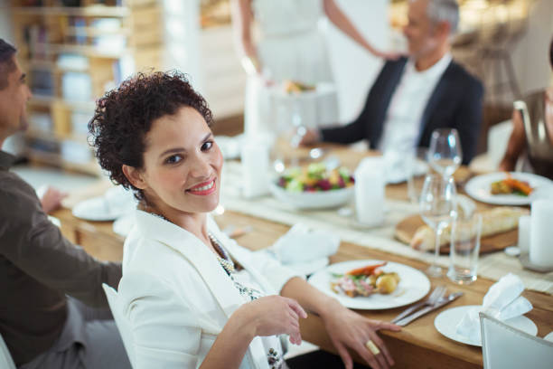 istock Woman smiling at dinner party 505937083