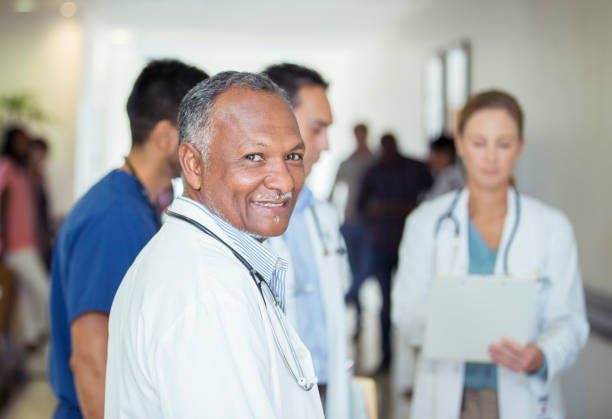 istock Doctor smiling in hospital hallway 505937109