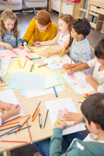 istock Students and teacher drawing in classroom 505937311