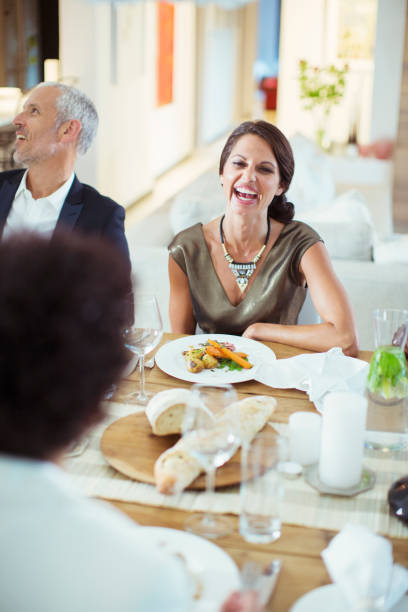 istock Woman laughing at dinner party 505937317