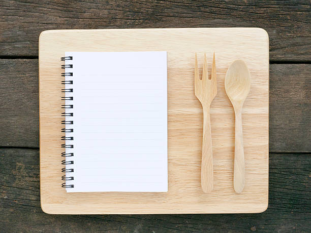 istock The white note book and wooden fork 505938716
