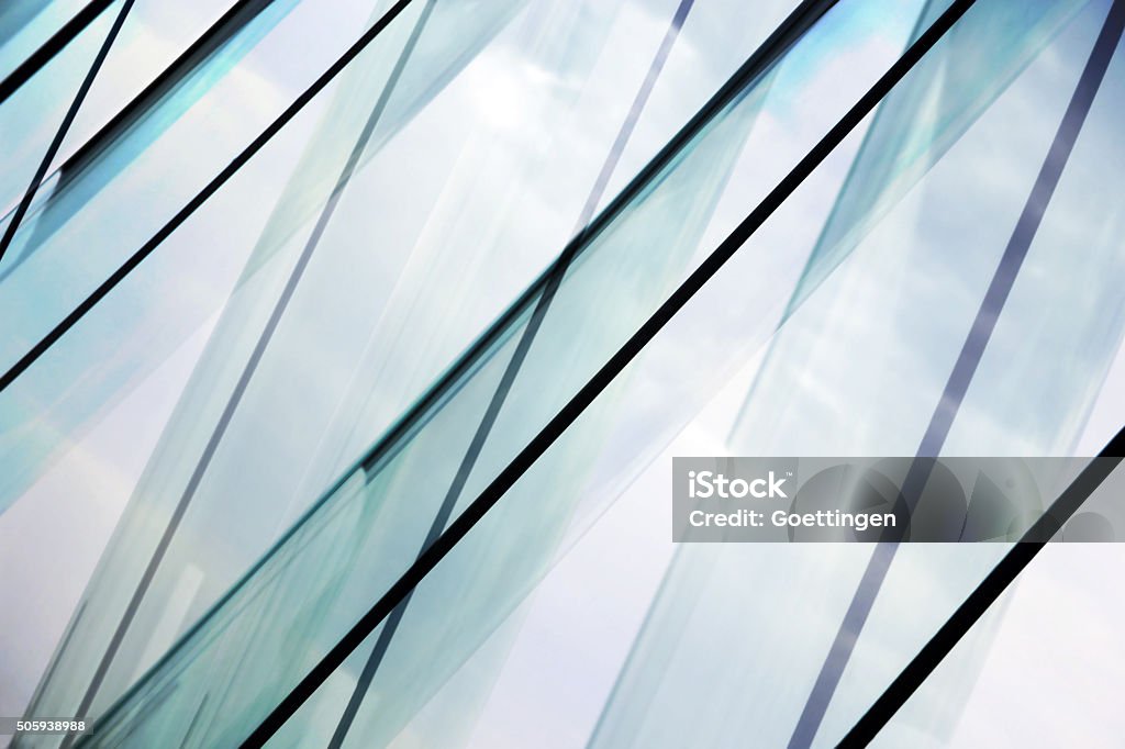Glass architecture. Double-exposure tilt photo of contemporary office building facade. Glass architecture. Tilt double exposure photo of modern office building facade. Sample of dynamic business cityscape. Abstract high-technology composition with all-over glazing. Glass - Material Stock Photo